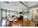 Bright and airy living room with hardwood floors, large windows, and custom built-in shelving at 16515 Governors Club Ct, Charlotte, NC 28278