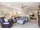 Open living space with comfortable seating, neutral tones, and a view to the foyer and stairwell at 16515 Governors Club Ct, Charlotte, NC 28278