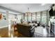 Bright living room featuring hardwood floors, large windows, and an open layout for modern living at 16515 Governors Club Ct, Charlotte, NC 28278