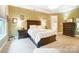 This main bedroom features neutral walls, carpet, a wooden bed frame and an ensuite bathroom at 16515 Governors Club Ct, Charlotte, NC 28278