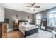 Bedroom featuring a black bed frame, windows for natural light, and neutral-toned decor at 16515 Governors Club Ct, Charlotte, NC 28278