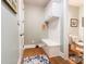 Mudroom with white bench, storage cabinets, and tile flooring at 16515 Governors Club Ct, Charlotte, NC 28278