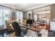 Office space with hardwood floors, natural light, and adjacent dining area at 16515 Governors Club Ct, Charlotte, NC 28278