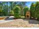 Backyard featuring a beautiful stone fireplace, landscaping, and outdoor pool at 16515 Governors Club Ct, Charlotte, NC 28278