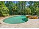 Inviting backyard pool and spa area with a travertine patio and lush landscaping at 16515 Governors Club Ct, Charlotte, NC 28278