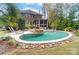 Expansive pool with a stone fire pit and spacious patio at 16515 Governors Club Ct, Charlotte, NC 28278