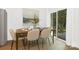 Dining area with wooden table, six chairs, and sliding door to backyard at 4205 Whispering Oaks Dr, Charlotte, NC 28213