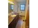 Modest bathroom featuring a single sink vanity, medicine cabinet, and window with natural light at 116 Lodge Hall Ct, Stony Point, NC 28678