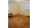 Bedroom featuring neutral colored walls and flooring with windows allowing for natural light at 116 Lodge Hall Ct, Stony Point, NC 28678