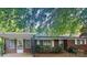 Charming brick home with a covered carport and mature trees, creating a welcoming curb appeal at 116 Lodge Hall Ct, Stony Point, NC 28678