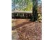 Charming brick home with a spacious front yard covered in fallen leaves, offering a cozy, seasonal appeal at 116 Lodge Hall Ct, Stony Point, NC 28678