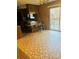 Retro-style kitchen with wood paneling, a breakfast bar, and sliding doors to a deck, blending functionality with style at 116 Lodge Hall Ct, Stony Point, NC 28678