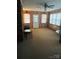Cozy living room with classic wood paneling, natural light, and a ceiling fan; ideal for relaxation at 116 Lodge Hall Ct, Stony Point, NC 28678