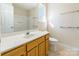 Well-lit bathroom features a single sink vanity, large mirror, and a shower-tub combination at 1305 Penny Oaks Cv, Rock Hill, SC 29732