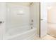 Clean bathroom shows a white shower-tub combination with an access door to the carpeted bedroom at 1305 Penny Oaks Cv, Rock Hill, SC 29732