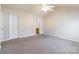 Light-filled bedroom features neutral carpet, a ceiling fan, and en-suite access at 1305 Penny Oaks Cv, Rock Hill, SC 29732