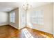 Bright dining area features wood floors, a window, and an elegant chandelier at 1305 Penny Oaks Cv, Rock Hill, SC 29732