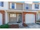 Inviting front entrance with brick accents, covered porch, and well-manicured landscaping at 1305 Penny Oaks Cv, Rock Hill, SC 29732