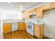 Functional kitchen featuring ample cabinetry, white appliances, and hardwood flooring at 1305 Penny Oaks Cv, Rock Hill, SC 29732