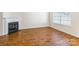 Bright living room featuring hardwood floors, a fireplace, and a large window at 1305 Penny Oaks Cv, Rock Hill, SC 29732