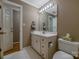 Bright bathroom featuring a white vanity with storage and a large, well-lit mirror at 3513 Country Club Dr, Gastonia, NC 28056