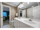 Bathroom featuring a double vanity with a large, well-lit mirror and white tile floors at 3513 Country Club Dr, Gastonia, NC 28056