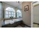 Serene bathroom with large arched windows and a luxurious soaking tub at 3513 Country Club Dr, Gastonia, NC 28056