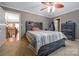 Bedroom with hardwood headboard and matching dresser, ceiling fan, and access to second floor at 3513 Country Club Dr, Gastonia, NC 28056