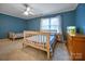 Bedroom with blue walls, two beds, white trim, and a window with sheer curtains at 3513 Country Club Dr, Gastonia, NC 28056