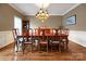 Formal dining room with hardwood floors, elegant chandelier, and ample space for entertaining at 3513 Country Club Dr, Gastonia, NC 28056