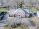 Aerial view of a stunning brick home with a well-manicured lawn and mature trees at 3513 Country Club Dr, Gastonia, NC 28056