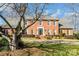 Charming two-story brick home featuring mature landscaping and a well-manicured front lawn at 3513 Country Club Dr, Gastonia, NC 28056