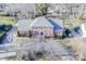 Well-maintained two-story brick home with mature trees, a meticulously kept lawn, and ample parking space at 3513 Country Club Dr, Gastonia, NC 28056