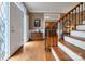 Inviting foyer with hardwood floors, staircase and decorative glass door leading into the home at 3513 Country Club Dr, Gastonia, NC 28056