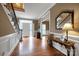 Bright foyer with hardwood floors, staircase with wrought iron, and views to formal dining room at 3513 Country Club Dr, Gastonia, NC 28056