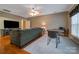 Living area with hardwood floors, a neutral color scheme, and ample seating and desk space at 3513 Country Club Dr, Gastonia, NC 28056