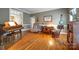 Charming living room featuring hardwood floors, piano, and comfortable seating area at 3513 Country Club Dr, Gastonia, NC 28056