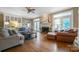Spacious living room with hardwood floors, fireplace, comfortable seating, and built-in cabinets at 3513 Country Club Dr, Gastonia, NC 28056