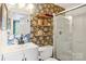 Bathroom with floral wallpaper, framed mirror, wooden floating shelves, and white vanity at 5300 Fair Wind Ln, Charlotte, NC 28212