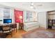 Well-lit bedroom features a trundle bed, built-in bookcase, desk, white curtains, and ample closet space at 5300 Fair Wind Ln, Charlotte, NC 28212