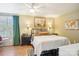 Bright bedroom features a ceiling fan, black night stands, and large picture window at 5300 Fair Wind Ln, Charlotte, NC 28212