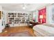 Bright bedroom featuring a wall of bookcases, a desk, and a trundle bed at 5300 Fair Wind Ln, Charlotte, NC 28212