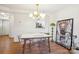 Bright dining room with modern chandelier, clear chairs, and artwork at 5300 Fair Wind Ln, Charlotte, NC 28212