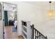 Hallway featuring hardwood floors, a built-in bookshelf, and natural lighting at 5300 Fair Wind Ln, Charlotte, NC 28212