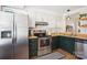 Functional kitchen with butcher block countertops, stainless steel appliances, and white cabinetry at 5300 Fair Wind Ln, Charlotte, NC 28212