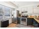 Well-lit kitchen with white cabinets, butcher block countertops, and stainless steel appliances at 5300 Fair Wind Ln, Charlotte, NC 28212