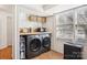 Bright laundry room featuring modern appliances, a butcher block countertop, and ample storage at 5300 Fair Wind Ln, Charlotte, NC 28212