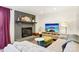Cozy living room featuring a brick fireplace, comfortable seating, and a television at 5300 Fair Wind Ln, Charlotte, NC 28212