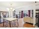 Open living and dining area with modern lighting, stylish furnishings, and wood floors at 5300 Fair Wind Ln, Charlotte, NC 28212