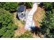 Drone eye-view of the house displaying its modern architecture, private balcony, and winding driveway lined with trees at 6534 Providence Rd, Charlotte, NC 28226